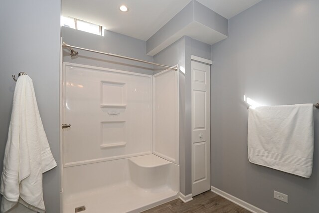 bathroom with a shower and wood-type flooring