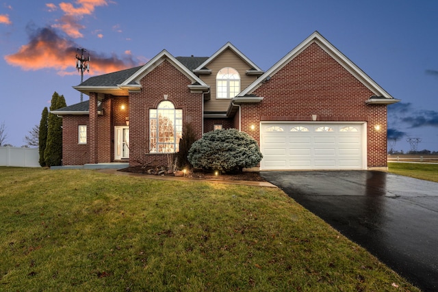 view of front property with a garage and a yard