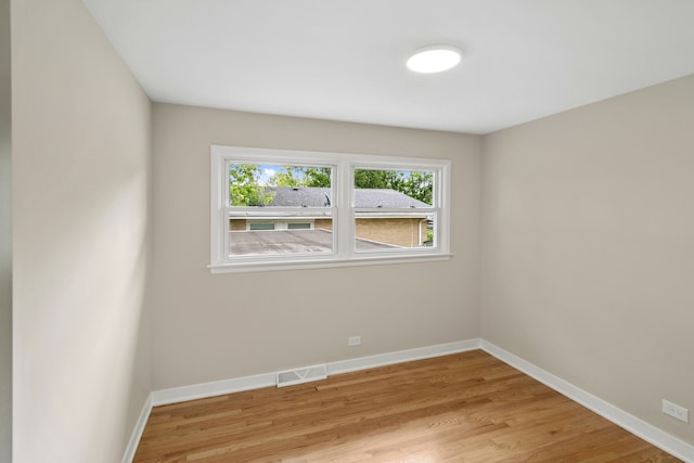 spare room with light hardwood / wood-style flooring