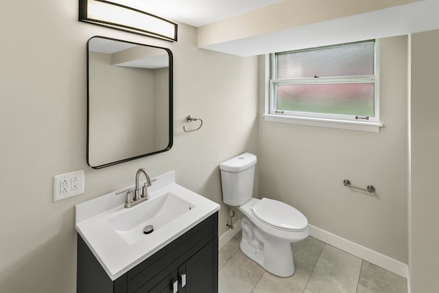 bathroom with tile patterned floors, vanity, and toilet