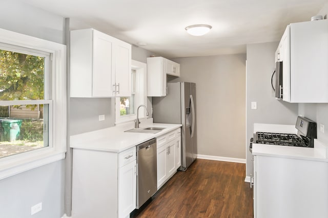 kitchen with sink, white cabinetry, stainless steel appliances, and dark hardwood / wood-style floors