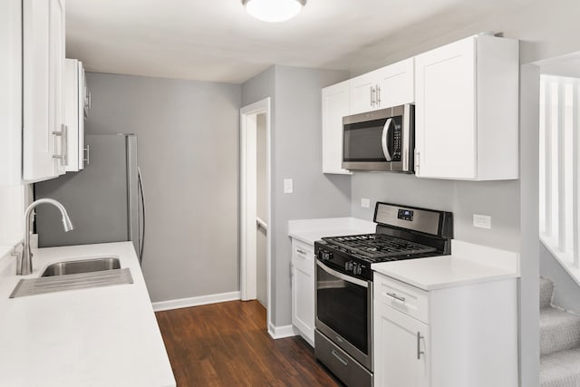 kitchen featuring white cabinetry, appliances with stainless steel finishes, dark hardwood / wood-style flooring, and sink