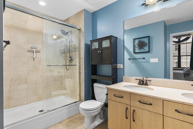 bathroom with tile patterned flooring, toilet, a shower with door, and vanity