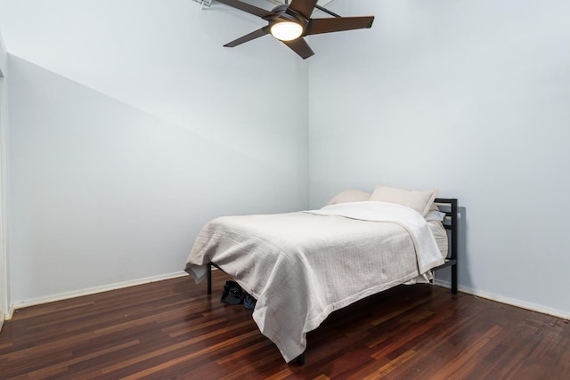 bedroom with ceiling fan and dark wood-type flooring