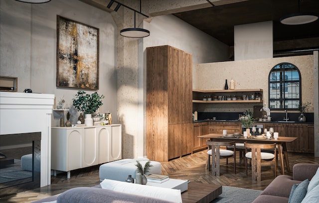 living room featuring parquet flooring, a high ceiling, and sink