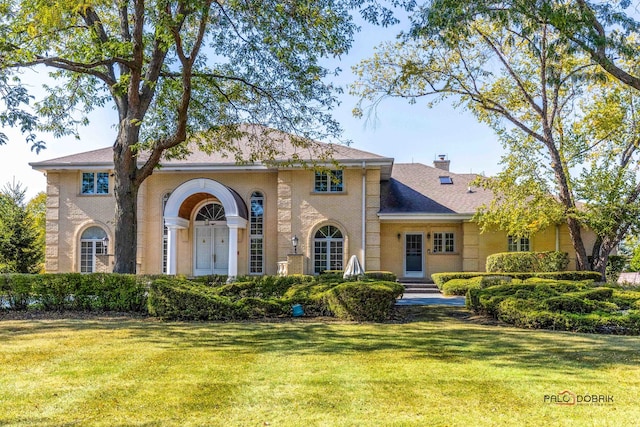 mediterranean / spanish-style home with a front yard