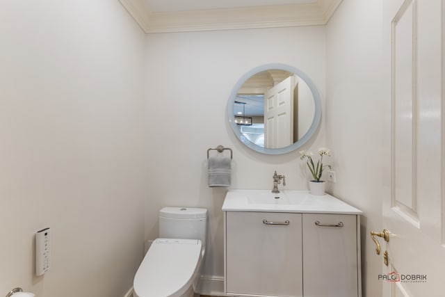 bathroom with vanity, ornamental molding, and toilet