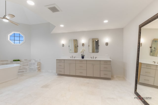 bathroom with vanity, a washtub, and ceiling fan