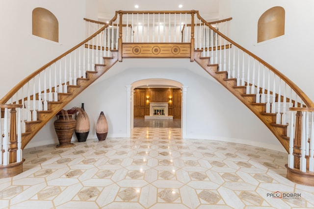 staircase featuring a high ceiling