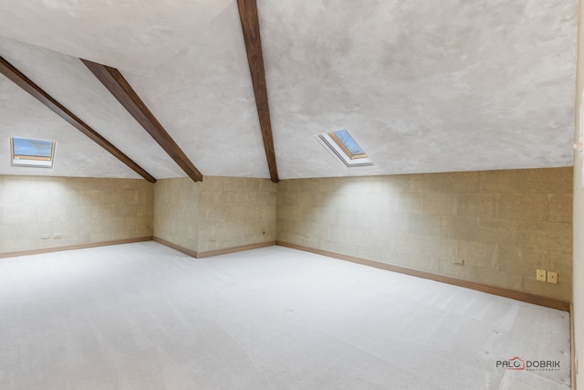 bonus room with lofted ceiling with skylight and light carpet