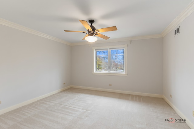 spare room with ornamental molding, light carpet, and ceiling fan