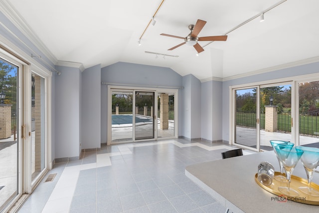 interior space with lofted ceiling, track lighting, ornamental molding, and ceiling fan