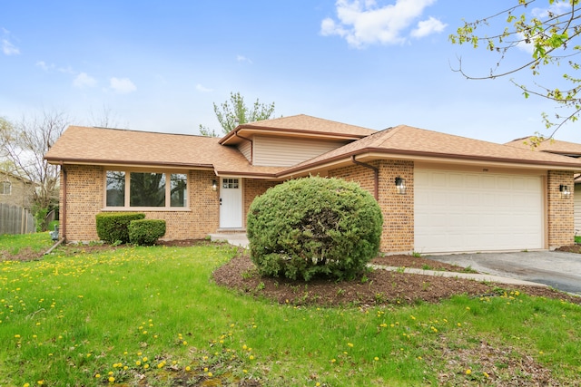 view of front of property featuring a garage and a front lawn