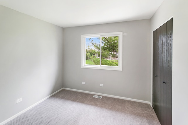 unfurnished room with carpet flooring