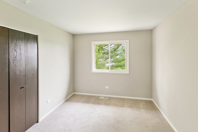 unfurnished bedroom with a closet and carpet floors