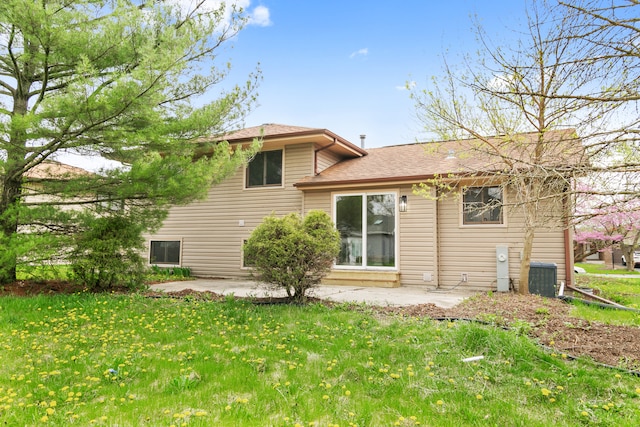 rear view of house with a yard, a patio area, and cooling unit