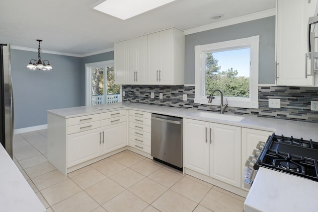 kitchen featuring sink, kitchen peninsula, stainless steel appliances, and a healthy amount of sunlight