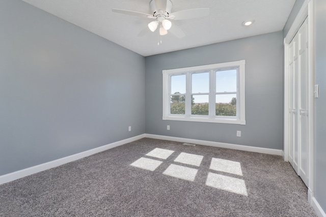 unfurnished bedroom featuring carpet and ceiling fan