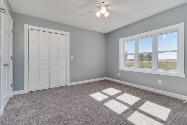 unfurnished bedroom with a closet, ceiling fan, and carpet