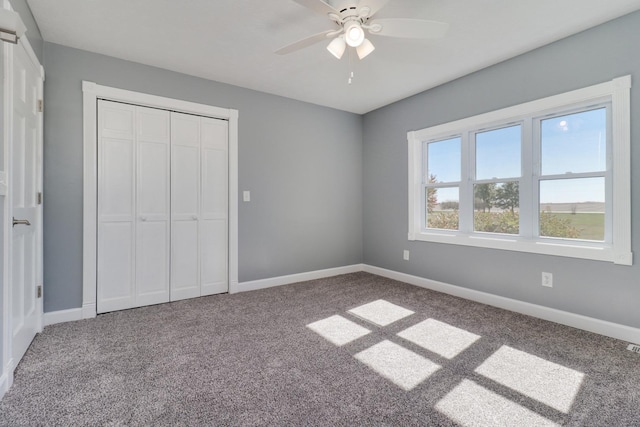 15054 E 2500 N Rd, Hudson, IL 61748 - unfurnished bedroom with carpet, baseboards, a closet, and a ceiling fan