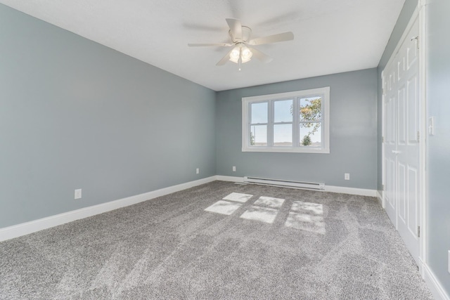 15054 E 2500 N Rd, Hudson, IL 61748 - unfurnished bedroom with a baseboard heating unit, baseboards, carpet, and a closet
