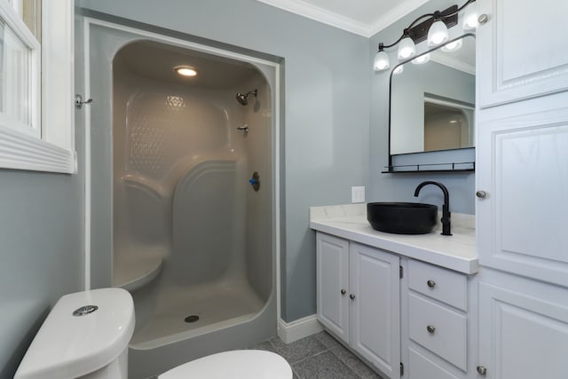 bathroom with tile patterned floors, toilet, ornamental molding, vanity, and walk in shower