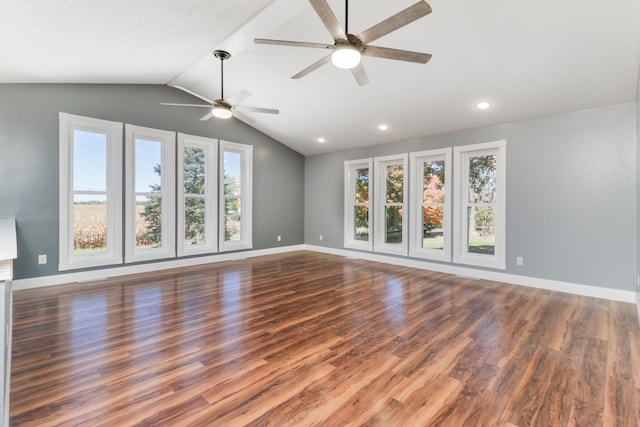 unfurnished living room featuring vaulted ceiling, dark hardwood / wood-style flooring, and ceiling fan