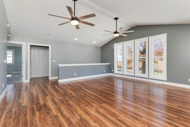 unfurnished living room with ceiling fan, dark wood-type flooring, and vaulted ceiling