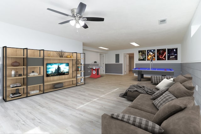 living room featuring light hardwood / wood-style flooring and ceiling fan