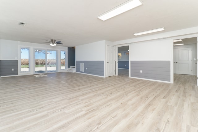 unfurnished living room with light hardwood / wood-style floors and ceiling fan