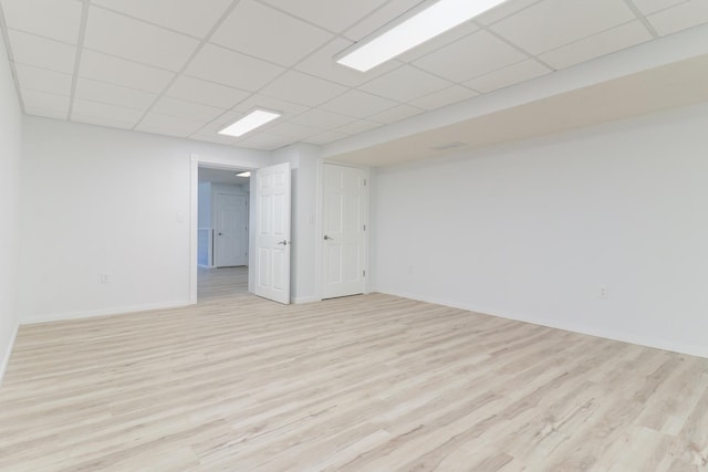 15054 E 2500 N Rd, Hudson, IL 61748 - empty room featuring light wood-style flooring, a drop ceiling, and baseboards
