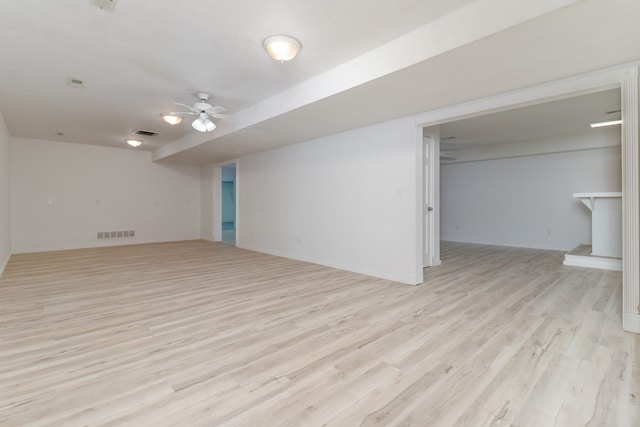 empty room with light wood-type flooring and ceiling fan