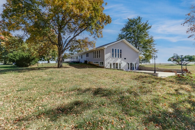 view of side of property featuring a yard