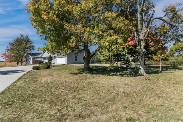 15054 E 2500 N Rd, Hudson, IL 61748 - view of green lawn featuring a playground and concrete driveway