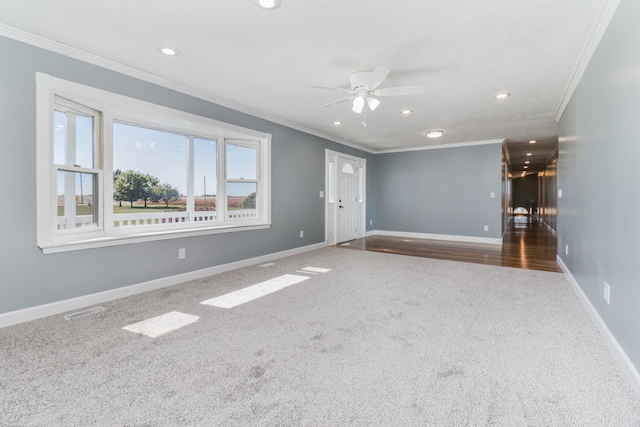 spare room featuring ornamental molding, hardwood / wood-style flooring, and ceiling fan