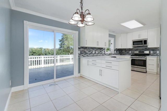 15054 E 2500 N Rd, Hudson, IL 61748 - kitchen featuring stainless steel appliances, backsplash, a chandelier, a peninsula, and white cabinets
