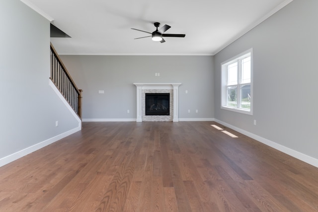 unfurnished living room with ceiling fan, wood-type flooring, and ornamental molding