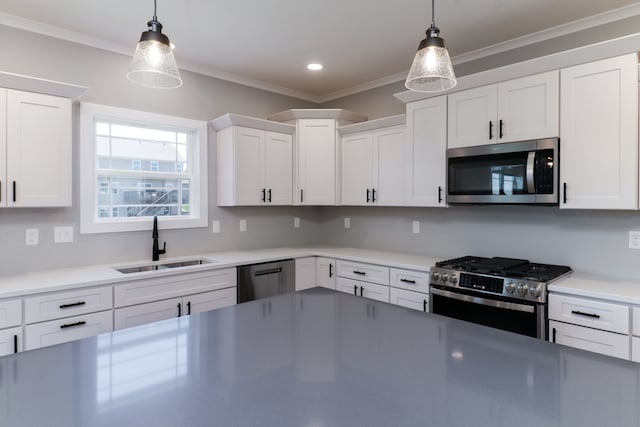 kitchen with pendant lighting, white cabinets, sink, and stainless steel appliances