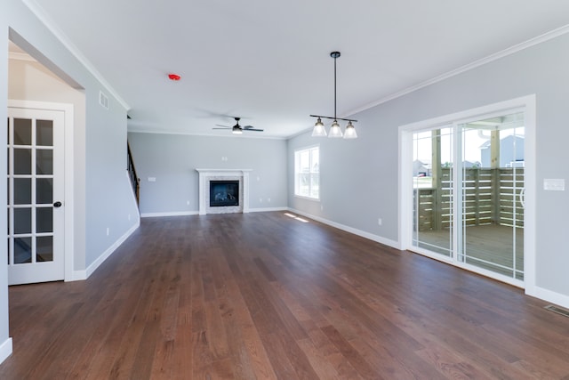 unfurnished living room with dark hardwood / wood-style floors, ceiling fan, and crown molding