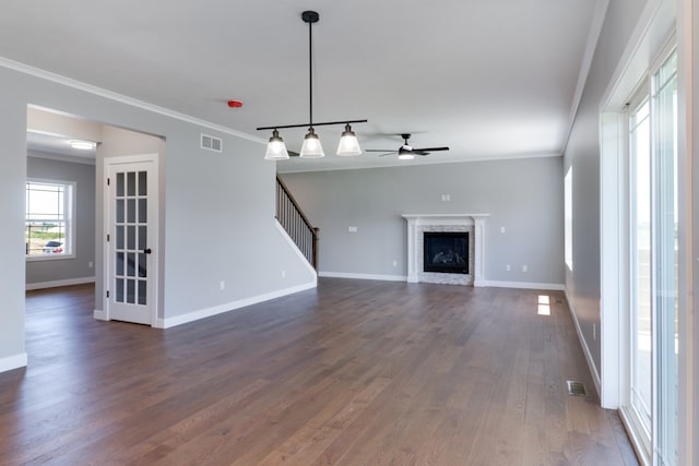 unfurnished living room with ceiling fan, dark hardwood / wood-style flooring, and ornamental molding