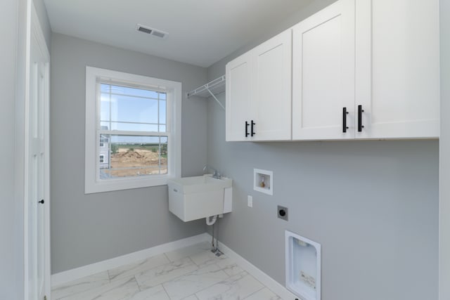 laundry area with electric dryer hookup, hookup for a washing machine, and cabinets