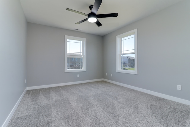 carpeted empty room featuring ceiling fan