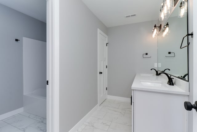 bathroom featuring vanity and a tub