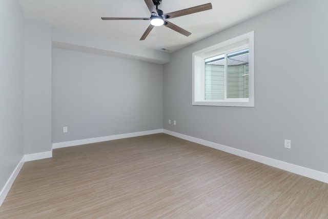 spare room featuring light hardwood / wood-style flooring and ceiling fan