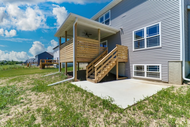 rear view of property with a patio and ceiling fan