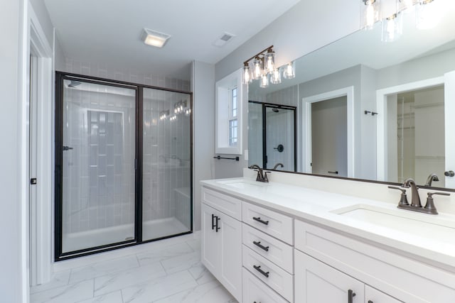 bathroom with vanity and a shower with door