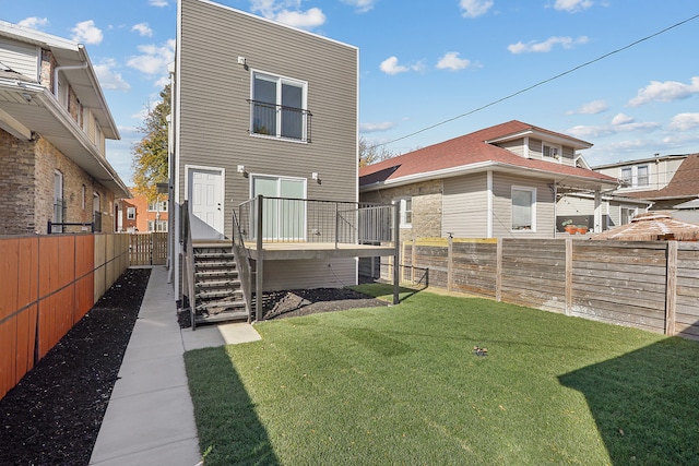 rear view of house with a yard