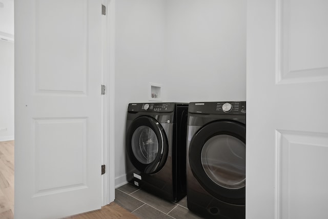 washroom featuring hardwood / wood-style floors and separate washer and dryer