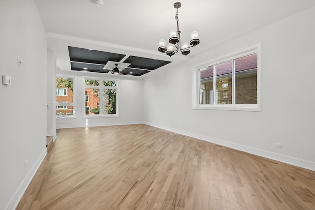 interior space with light hardwood / wood-style floors, coffered ceiling, and ceiling fan with notable chandelier