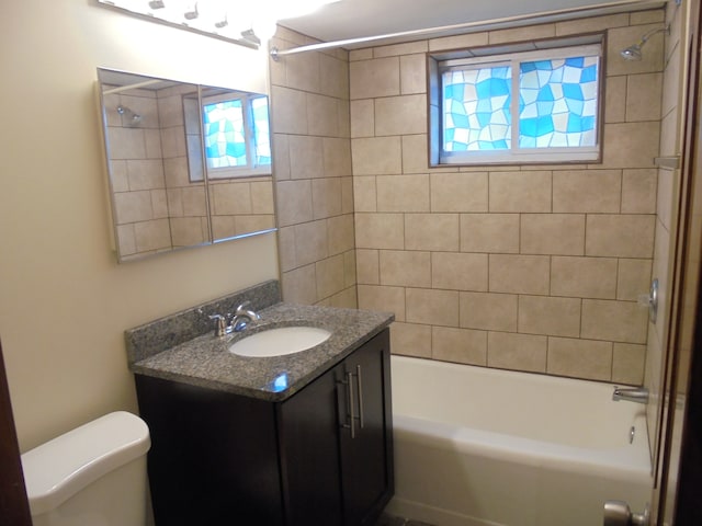 full bathroom with vanity, toilet, and tiled shower / bath